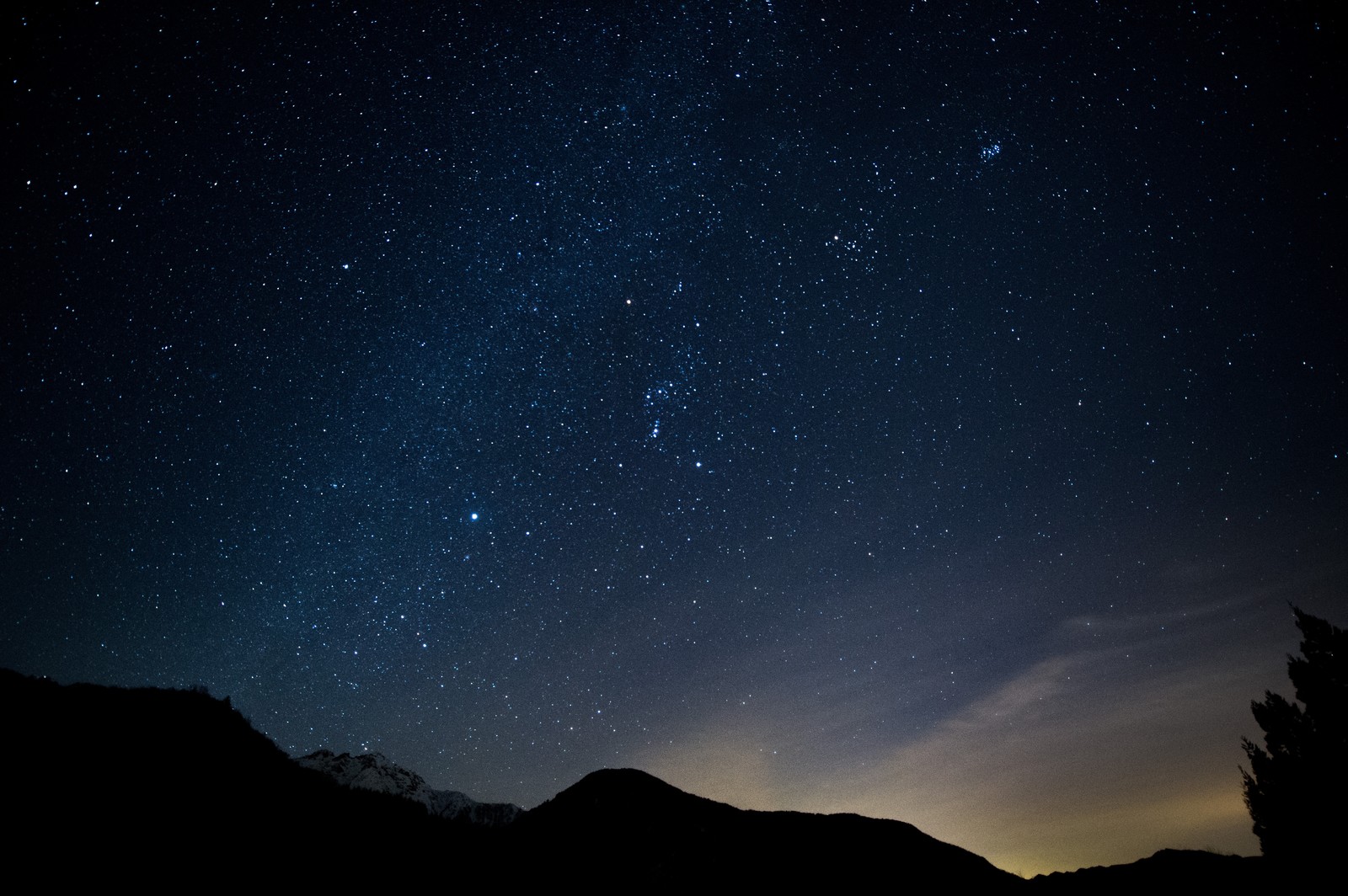 山のシルエットと星空（暗闇の中、山の上に広がる星空）