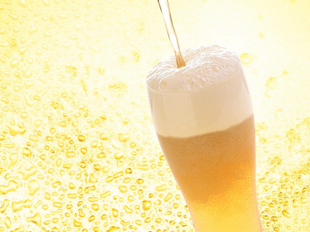 キンキンに冷えたビールが注がれている。ゴールドの背景に溶け込んでいる。