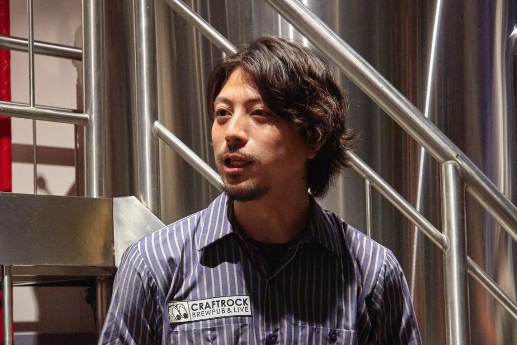 ブルーのストライプのシャツを着た、CRAFTROCK BREWINGの鈴木諒氏がインタビューに答えている。