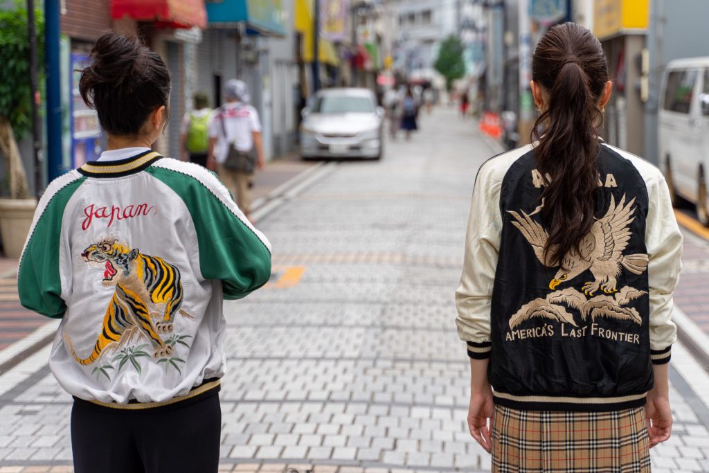 スカジャンを着て横須賀どぶ板通りを歩く女性二人