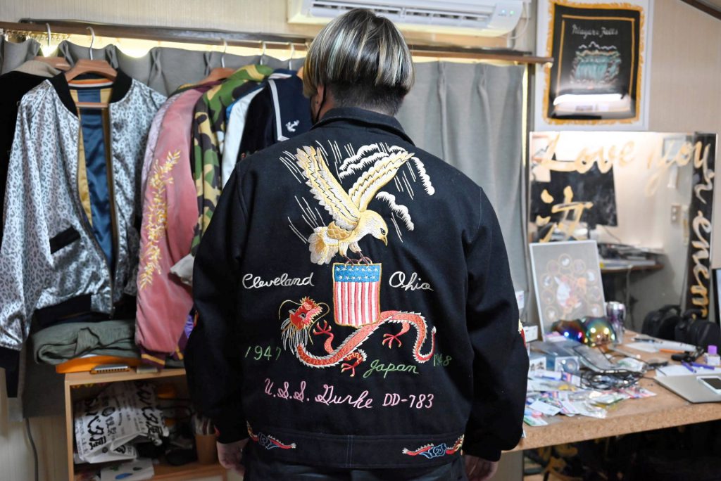 Hiromi Yokochi wears a sukajan jacket with traditional patterns of an eagle and dragon embroidered on his back.