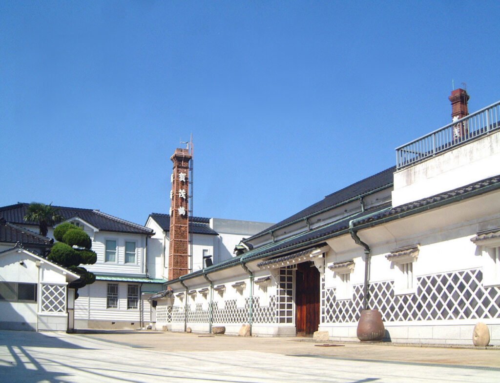 賀茂鶴酒造の和風な建物と煉瓦の煙突が見える外観